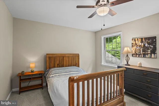 a bedroom with a bed and a lamp on table