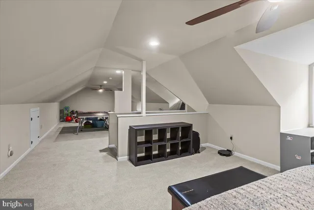a bedroom with a bed and ceiling fan
