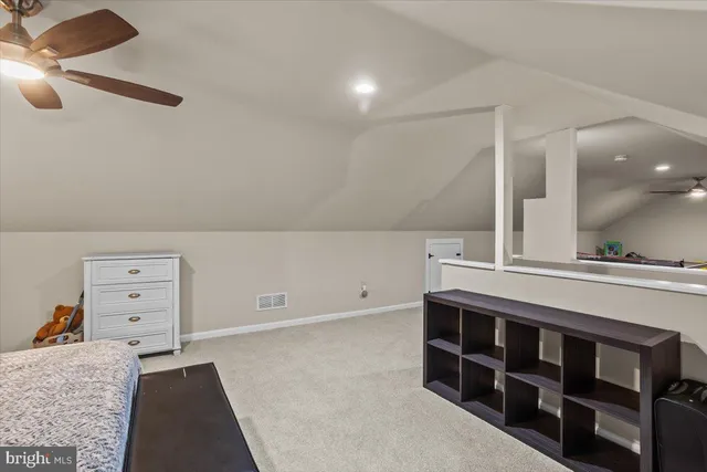 a room with lots of furniture and lots of frames on the wall