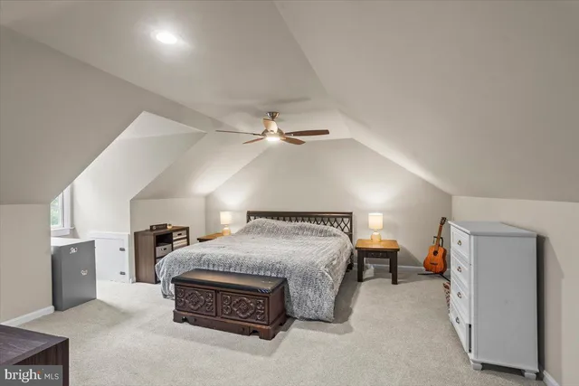 a bathroom with a granite countertop toilet a sink and a mirror