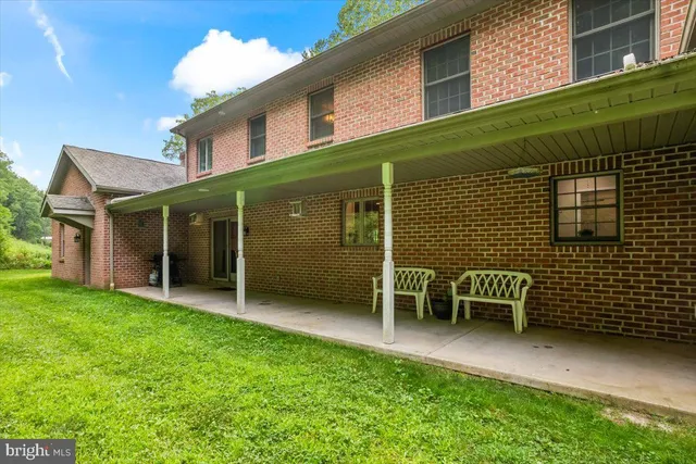 a view of a house with a yard porch and sitting area