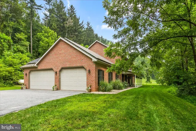 an aerial view of a house with a yard basket ball court and outdoor seating