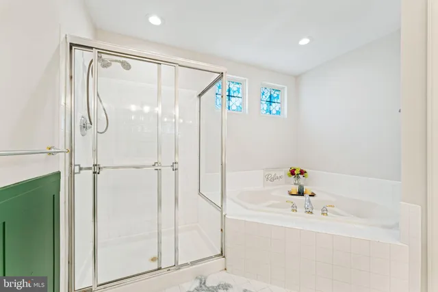 a bathroom with a bathtub and a shower