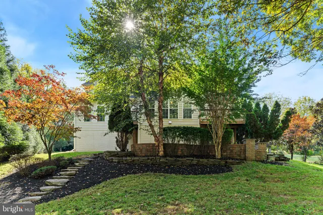 a view of a house with a yard and tree s