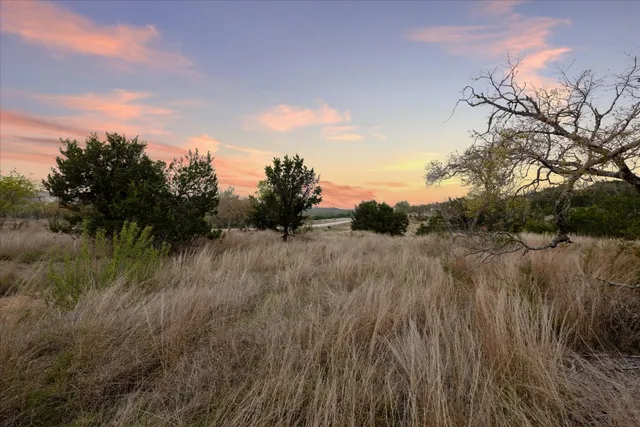 a view of a outdoor space with green field and mountains
