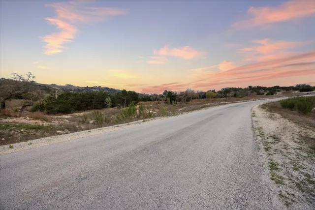 a view of a road with a big yard