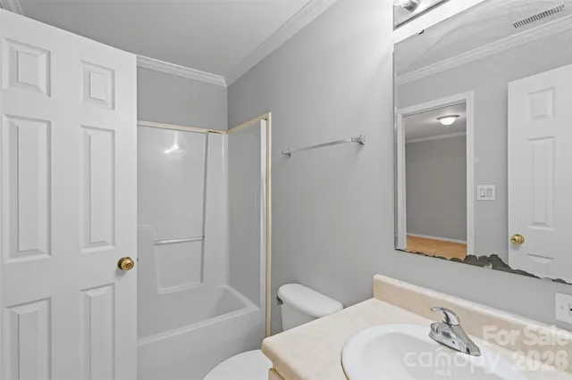 a bathroom with a sink a toilet and mirror