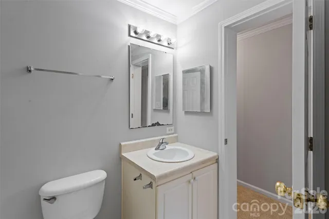 a bathroom with a sink a toilet and mirror