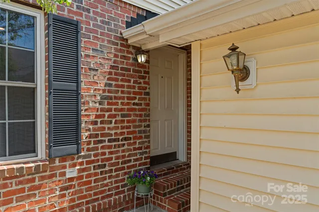 a view of a hallway with wooden floor and closet