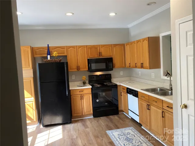 a kitchen with stainless steel appliances granite countertop a sink and a stove top oven