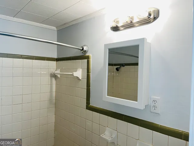 a bathroom with a shower and a mirror