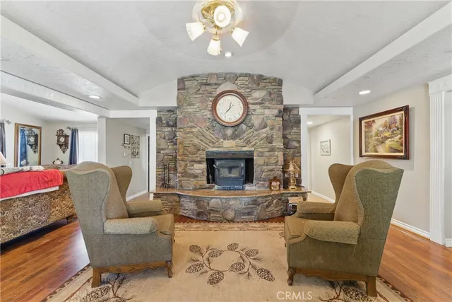 a kitchen with stainless steel appliances granite countertop a table chairs and a refrigerator