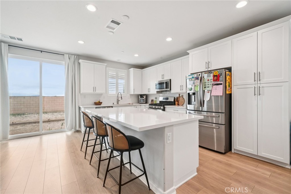 14270 Hercules Street Hesperia, CA 92345 - Photo 17 of 46 a kitchen with stainless steel appliances a refrigerator and a stove top oven