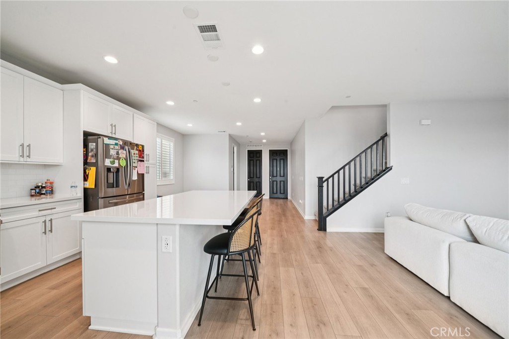 14270 Hercules Street Hesperia, CA 92345 - Photo 22 of 46 a view of kitchen with cabinets and wooden floor