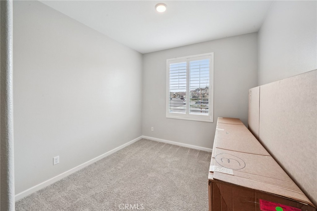 14270 Hercules Street Hesperia, CA 92345 - Photo 24 of 46 an empty room with a white cabinet and a window