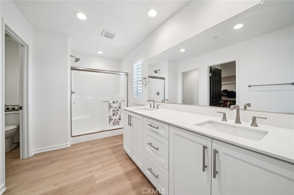 14270 Hercules Street Hesperia, CA 92345 - Photo 32 of 46 a spacious bathroom with a shower a sink and a mirror