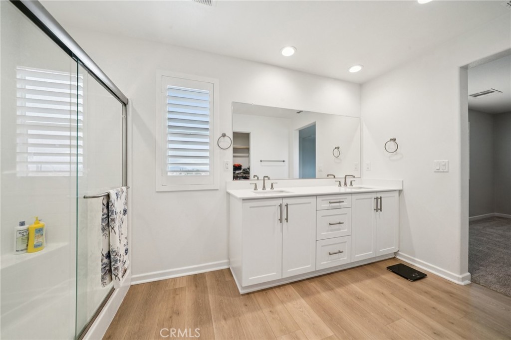 14270 Hercules Street Hesperia, CA 92345 - Photo 34 of 46 a spacious bathroom with a double vanity sink a mirror and a bathtub