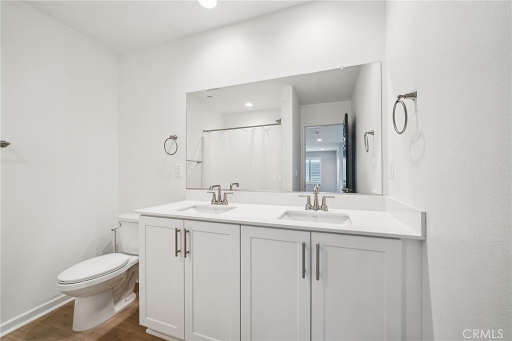 14270 Hercules Street Hesperia, CA 92345 - Photo 38 of 46 a bathroom with a toilet a sink and mirror