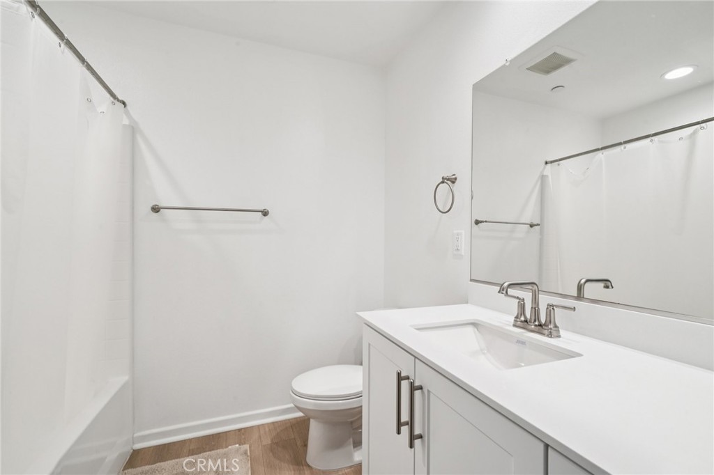14270 Hercules Street Hesperia, CA 92345 - Photo 39 of 46 a bathroom with a sink a toilet and a mirror