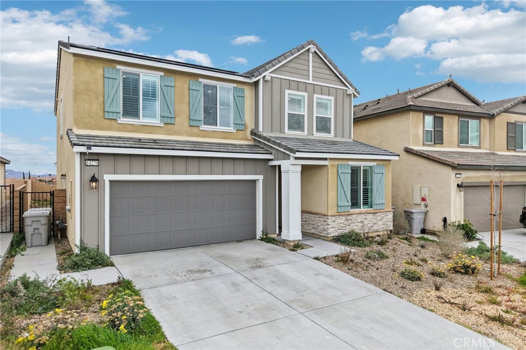 14270 Hercules Street Hesperia, CA 92345 - Photo 4 of 46 a front view of a house with a yard and garage