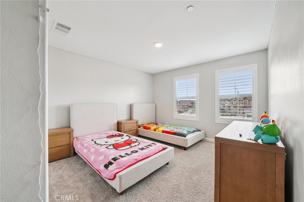 14270 Hercules Street Hesperia, CA 92345 - Photo 42 of 46 a bedroom with a bed table and window