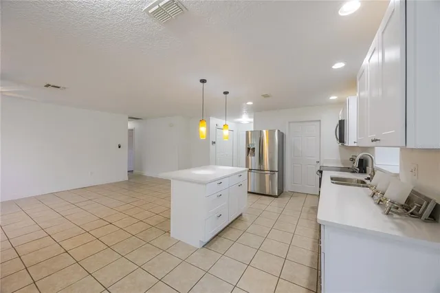 a kitchen with a sink cabinets and stainless steel appliances