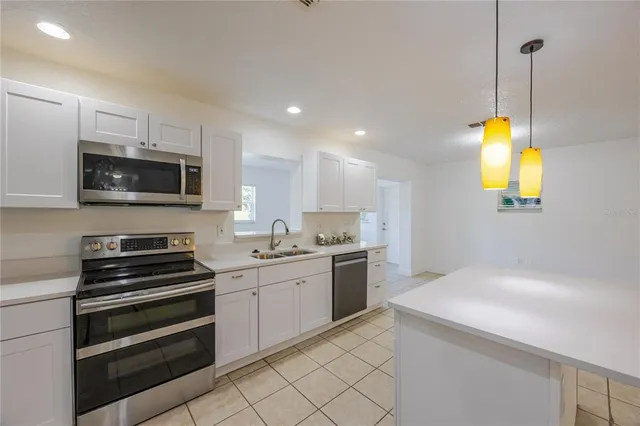 a kitchen with a sink and stainless steel appliances
