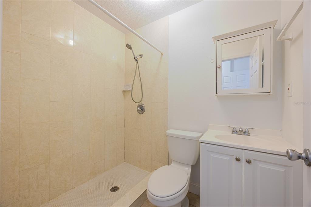 495 Orange Avenue St. Cloud, FL 34769 - Photo 18 of 32 a white toilet sitting next to a bathroom sink