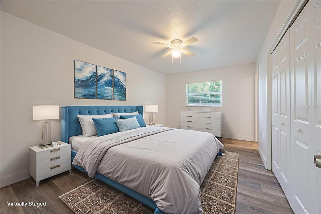 495 Orange Avenue St. Cloud, FL 34769 - Photo 24 of 32 a bedroom with a bed and a painting on the wall