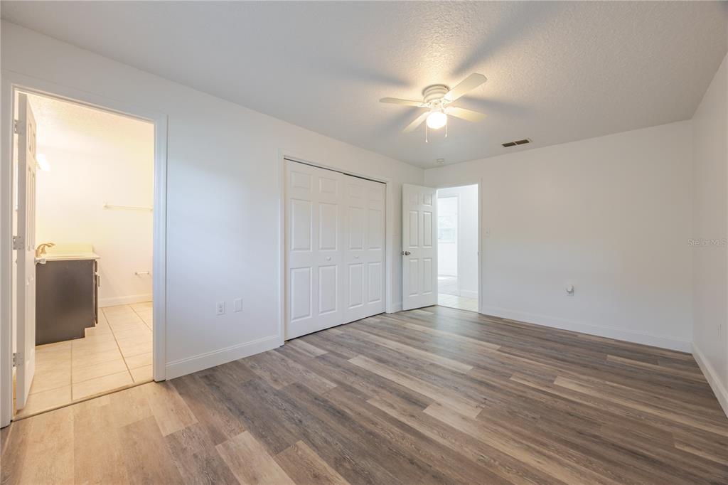 495 Orange Avenue St. Cloud, FL 34769 - Photo 25 of 32 a view of an empty room with wooden floor and a window