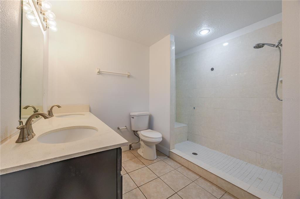 495 Orange Avenue St. Cloud, FL 34769 - Photo 26 of 32 a bathroom with a sink a toilet and shower