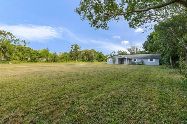 a view of a big house with a big yard