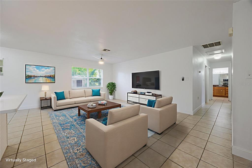 495 Orange Avenue St. Cloud, FL 34769 - Photo 7 of 32 a living room with furniture and a flat screen tv