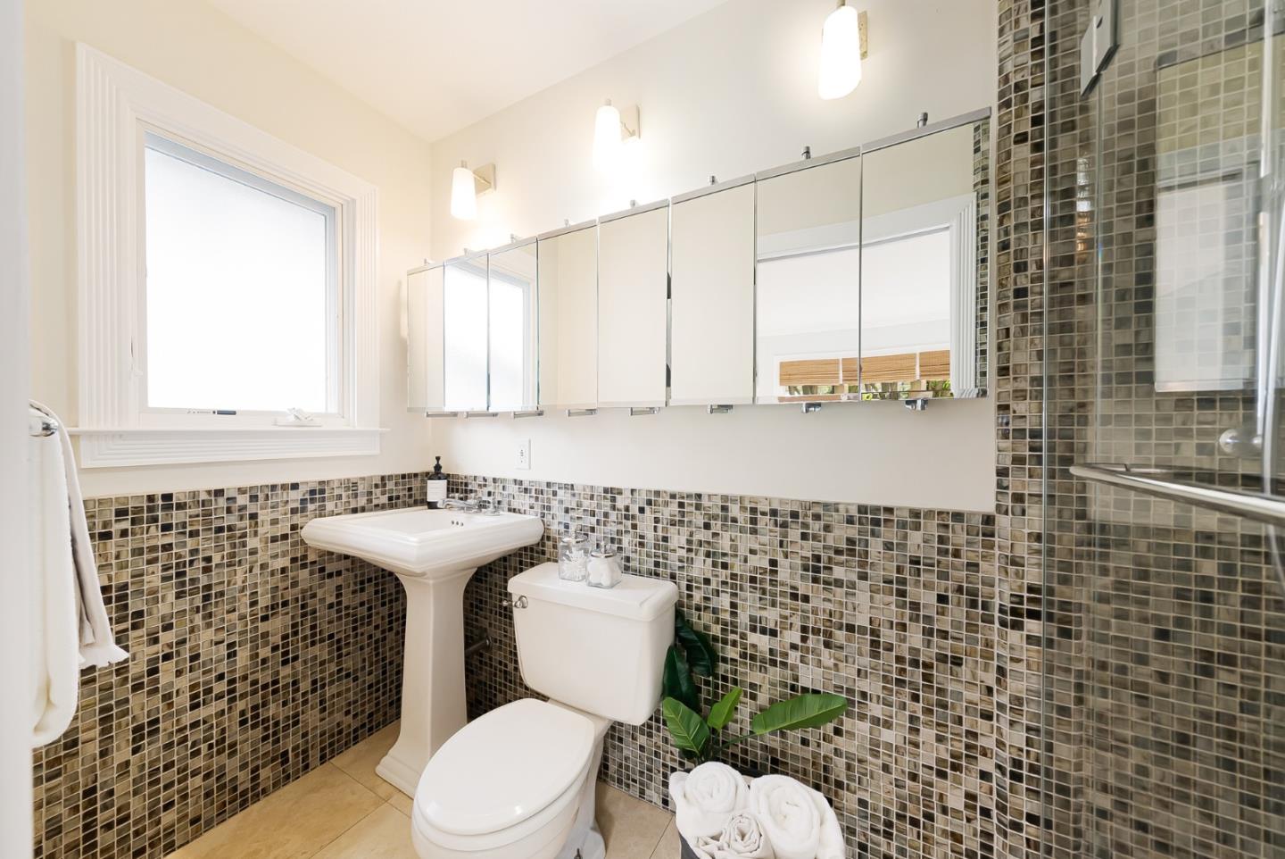2211 Ewell Road Belmont, CA 94002 - Photo 18 of 44 a bathroom with a toilet sink and mirror