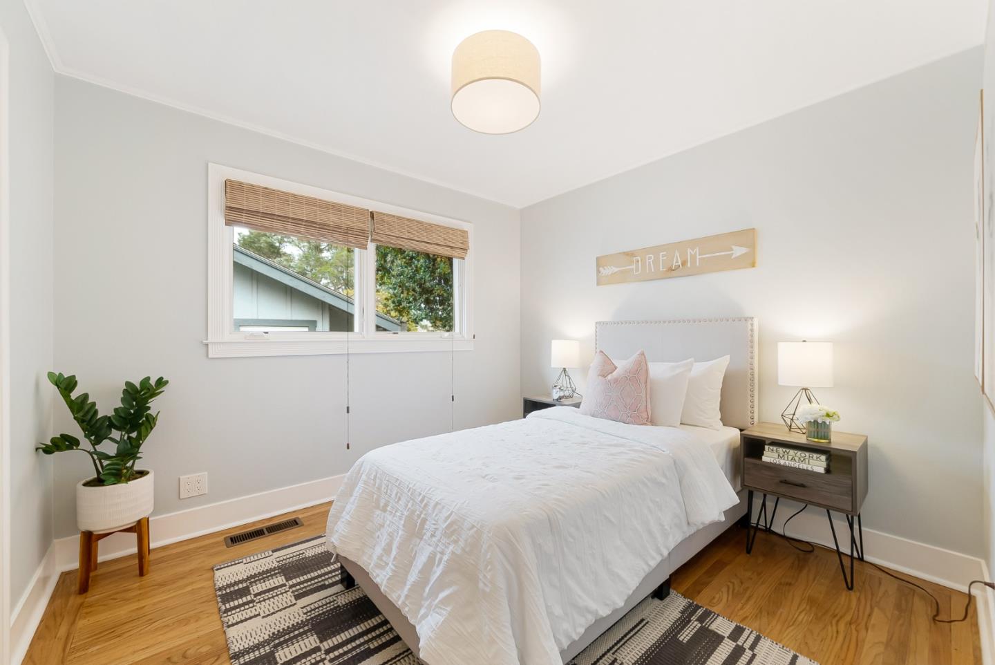 2211 Ewell Road Belmont, CA 94002 - Photo 20 of 44 a bedroom with a bed table and a potted plant