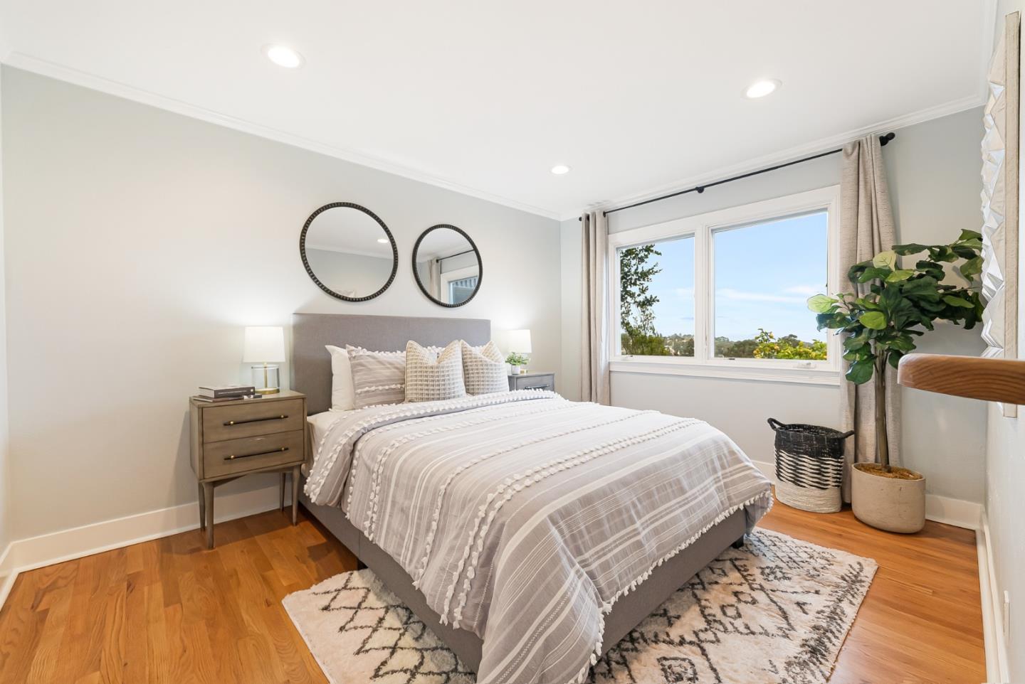 2211 Ewell Road Belmont, CA 94002 - Photo 22 of 44 a bedroom with a bed and a potted plant