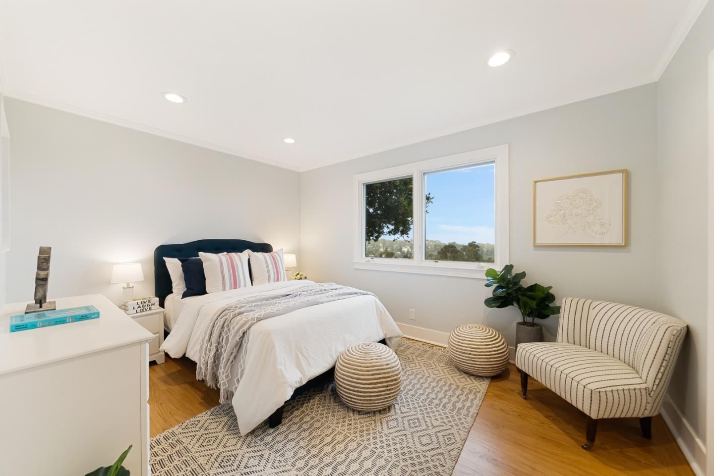 2211 Ewell Road Belmont, CA 94002 - Photo 28 of 44 a bedroom with a bed and a couch