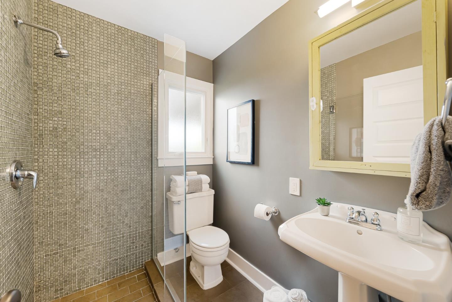 2211 Ewell Road Belmont, CA 94002 - Photo 29 of 44 a bathroom with a toilet sink vanity and mirror