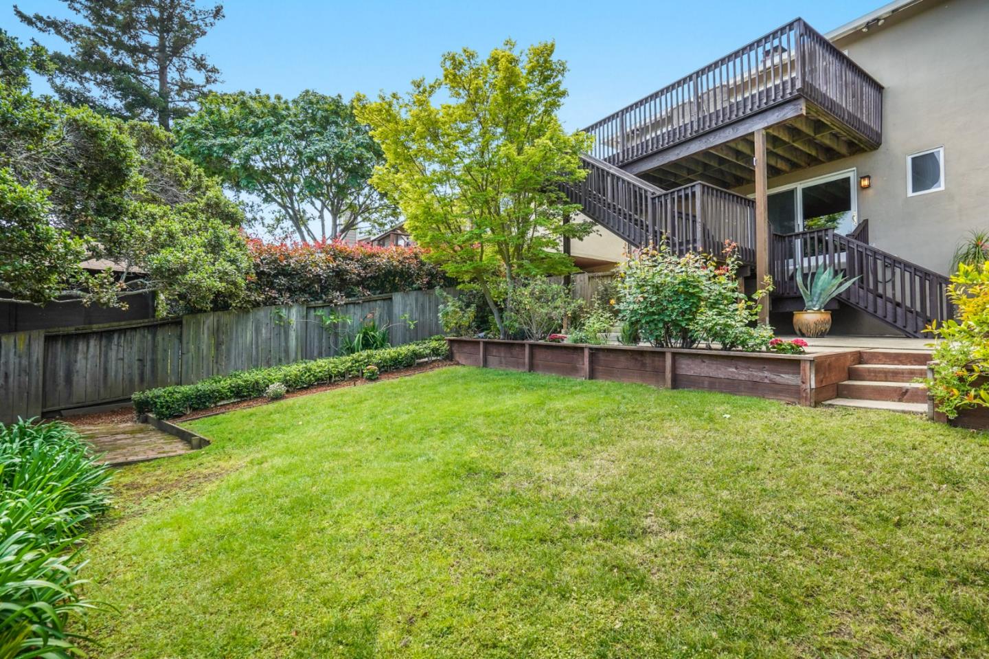 2211 Ewell Road Belmont, CA 94002 - Photo 35 of 44 a view of a backyard with plants and a garden