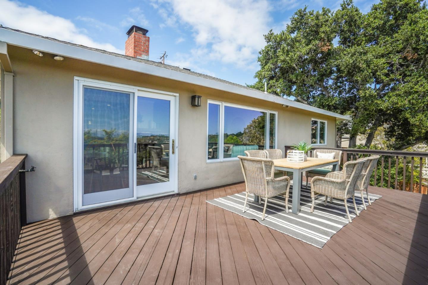 2211 Ewell Road Belmont, CA 94002 - Photo 10 of 44 a view of a patio with table and chairs and wooden floor