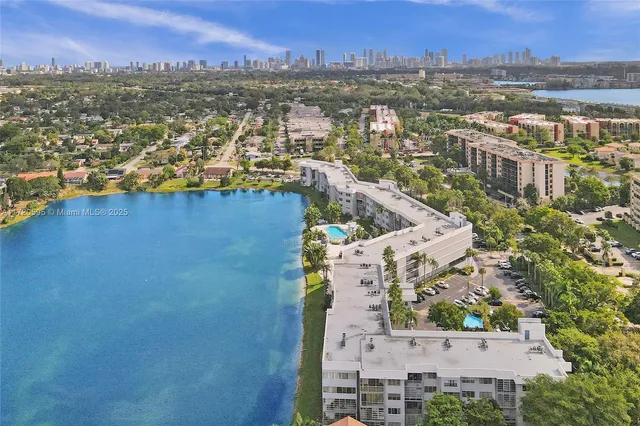 a dining room with furniture and a floor to ceiling window