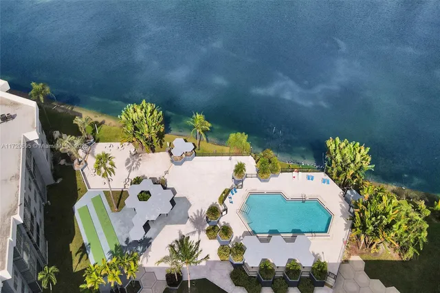 a living room with furniture a flat screen tv and kitchen view