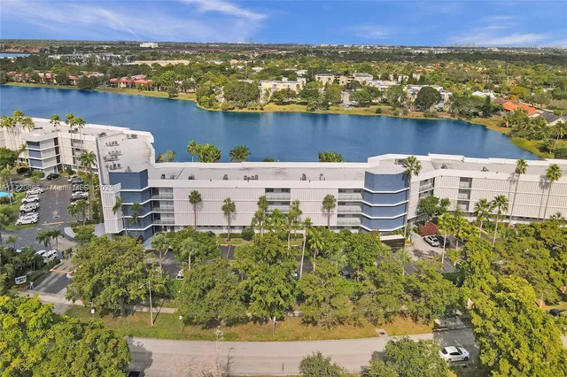 a living room with furniture a couch and a large window