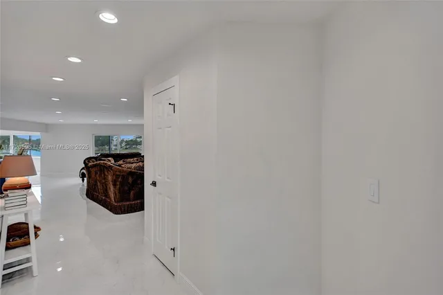 a living room with furniture a couch and a large window