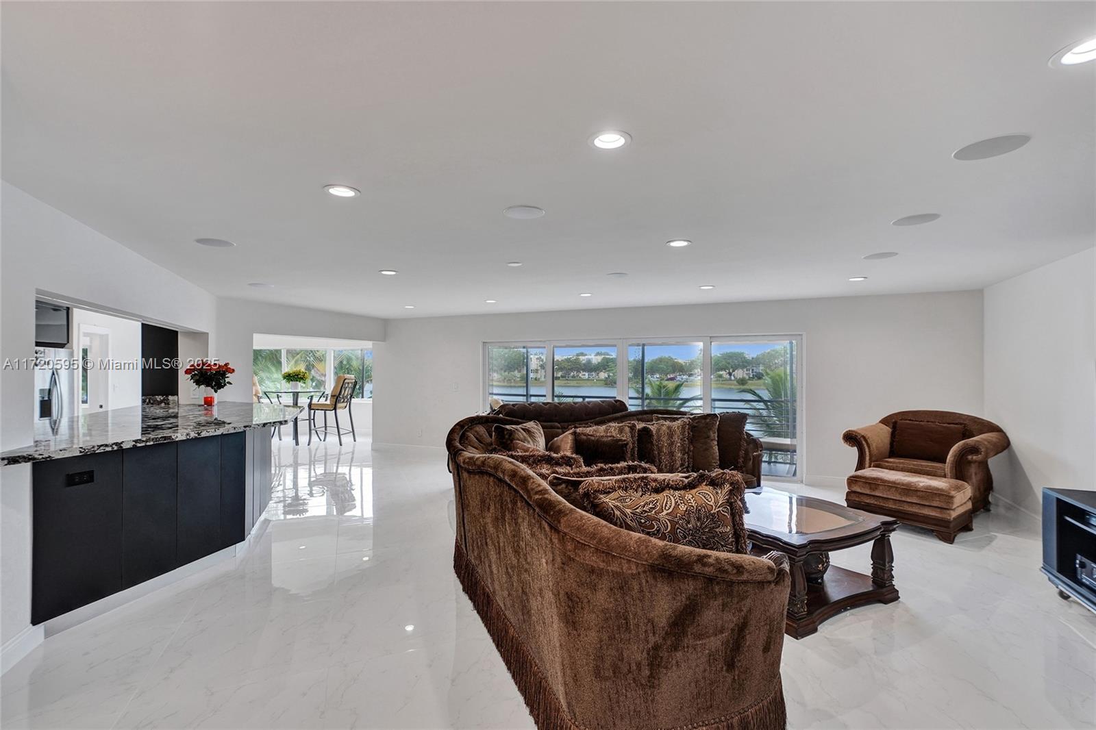 877 Northeast 195th Street, Unit 222 Miami, FL 33179 - Photo 21 of 93 a living room with furniture and a flat screen tv
