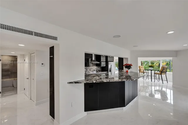 a living room with furniture and flowers
