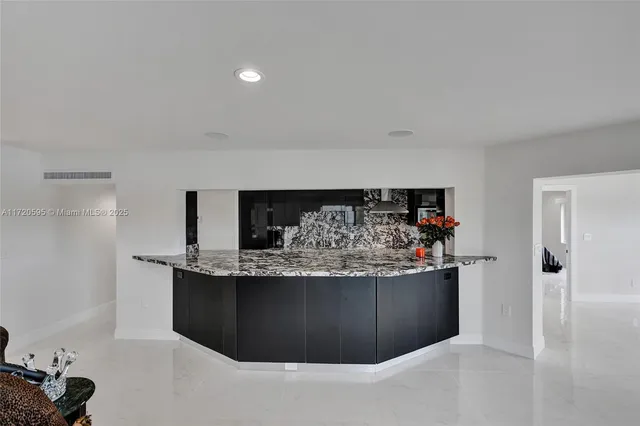 a kitchen with stainless steel appliances a refrigerator and a stove
