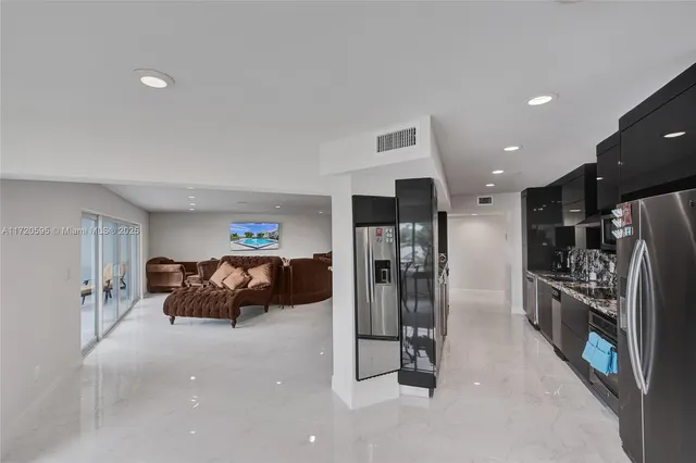 a dining room with furniture and a floor to ceiling window