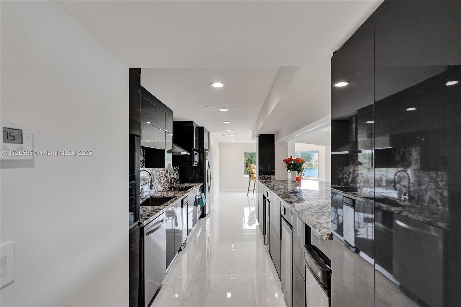 877 Northeast 195th Street, Unit 222 Miami, FL 33179 - Photo 31 of 93 a kitchen with stainless steel appliances kitchen island granite countertop a stove and a sink