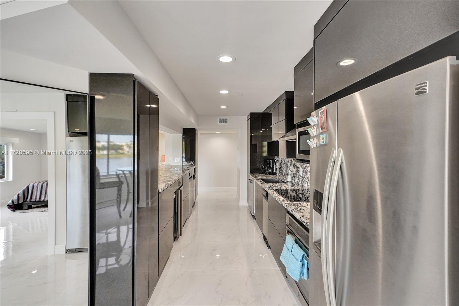 877 Northeast 195th Street, Unit 222 Miami, FL 33179 - Photo 40 of 93 a kitchen with stainless steel appliances a refrigerator and a stove